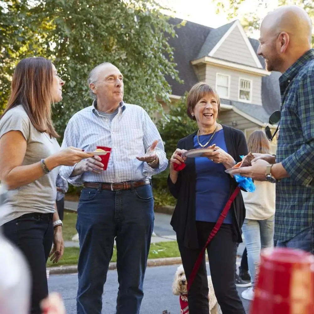 Grandparents and a grandchild together at an outdoor family gathering